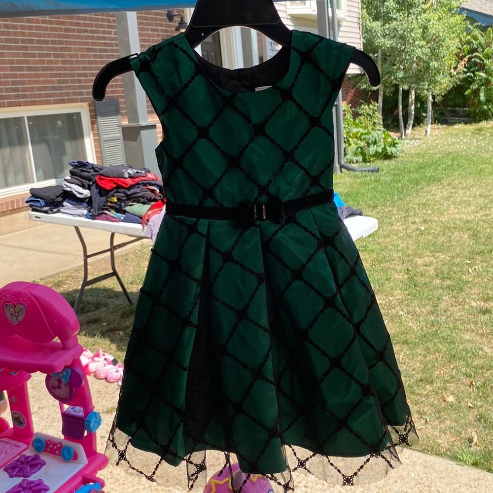 A green and black Dress it’s glittery.my younger sister only wore it once